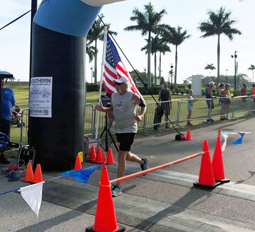 Runderful Apparel Runner finishing 5K race while running with American Flag